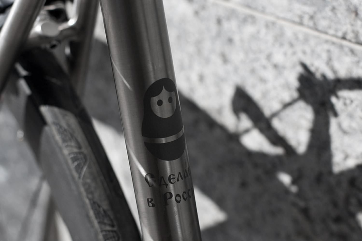 Close detail of a matryoshka stencil on a titanium tube