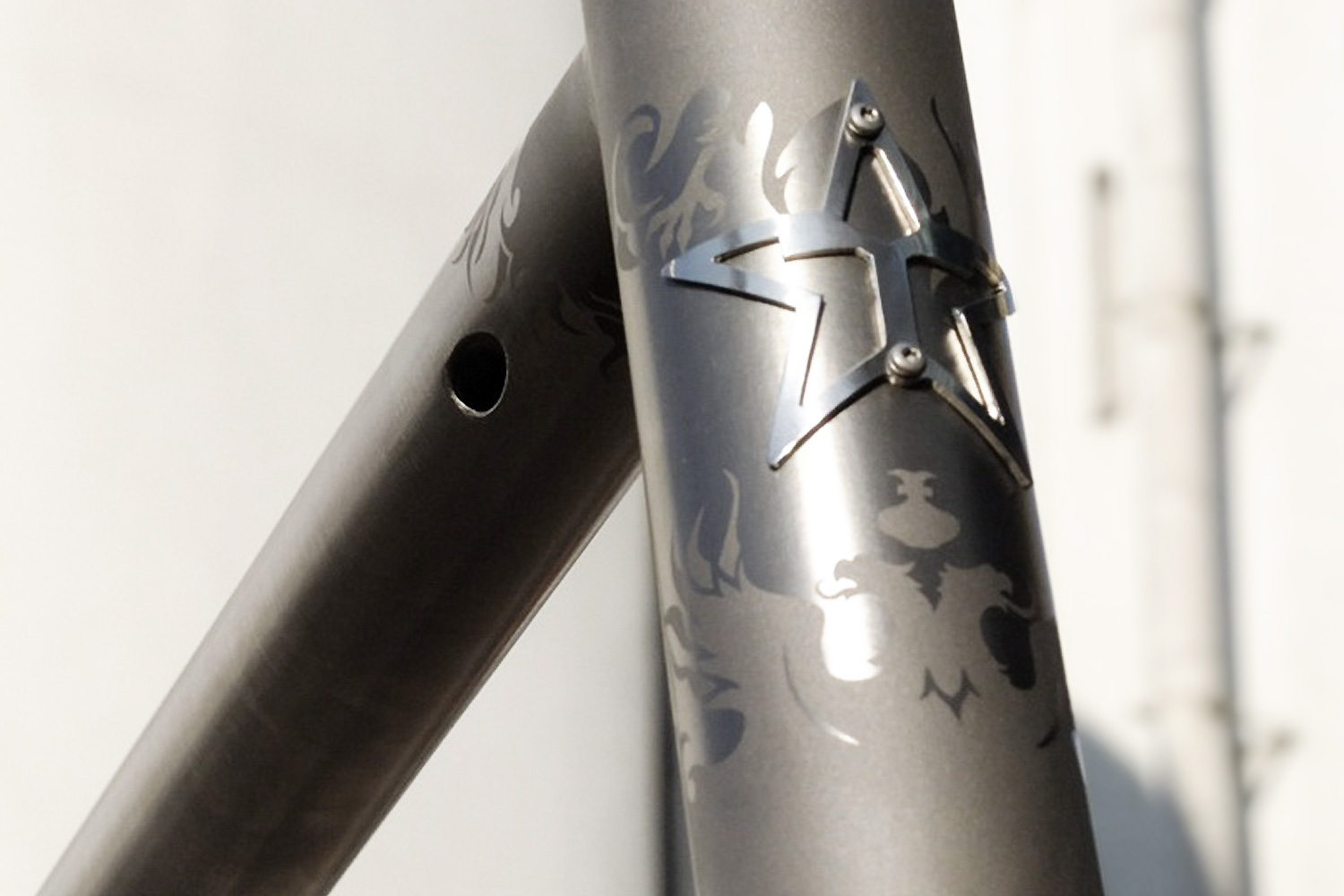 Star stencil and a hand-drawn figure on a titanium bicycle frame