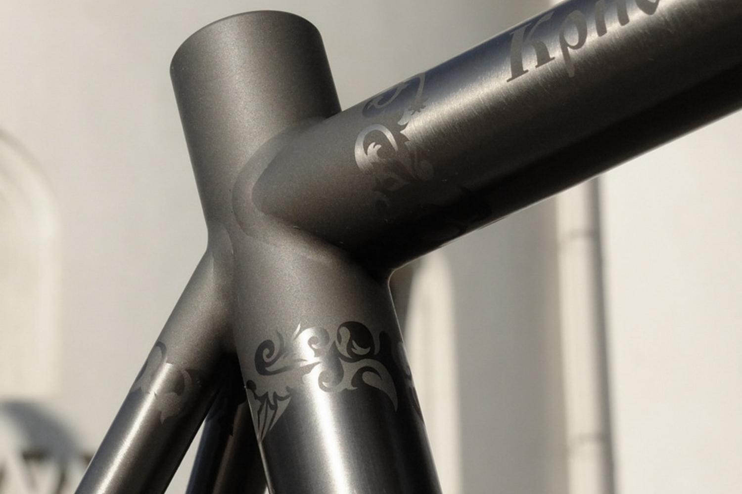 Floral stencil graphics on the junction of a titanium frame