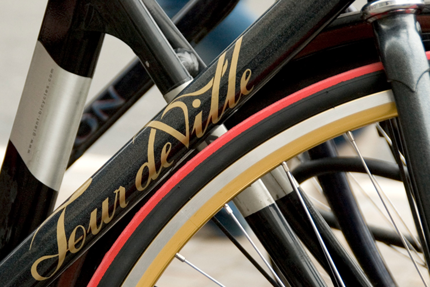 Tour deVille logo applied in gold on a bicycle frame