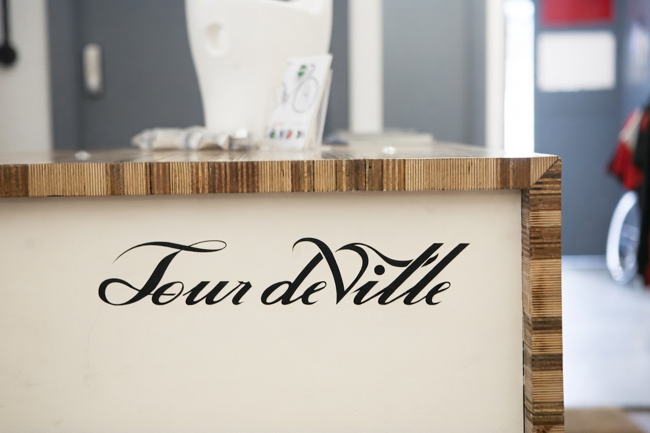 Tour deVille logo painted on the shop counter