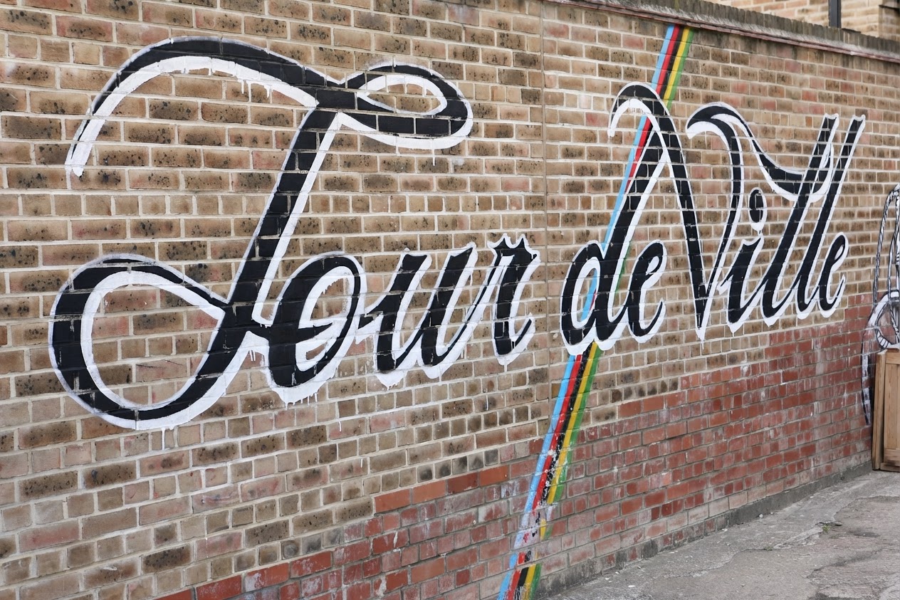 Tour deVille logo painted across the brick wall outside the London Fields shop